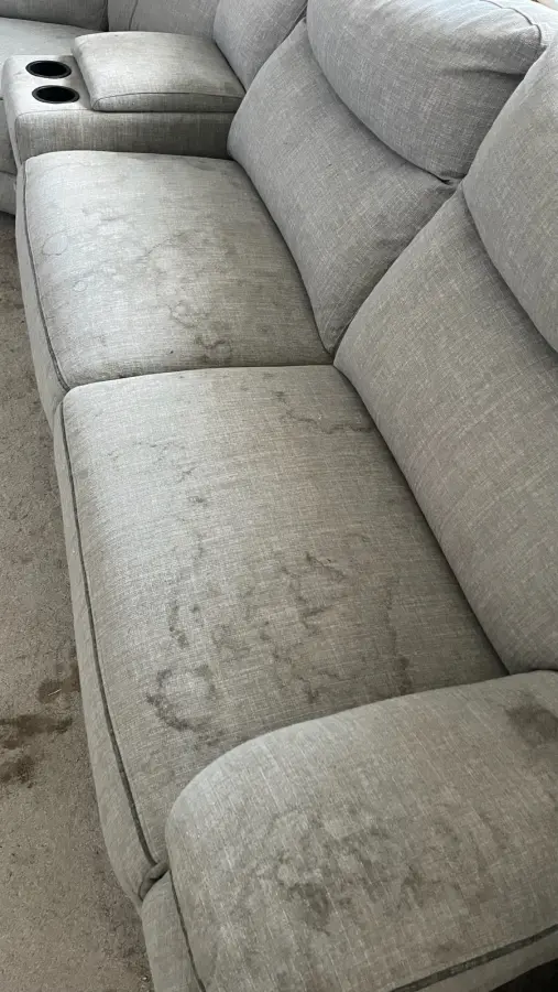 Heavily soiled sofa before cleaning